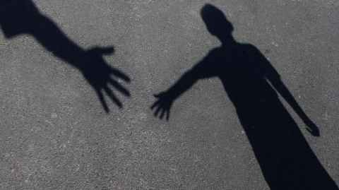 shadow of hands reaching out