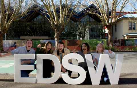 Students behind EDSW letters